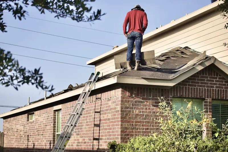 Professional roofer working on a residential roof in Mustang